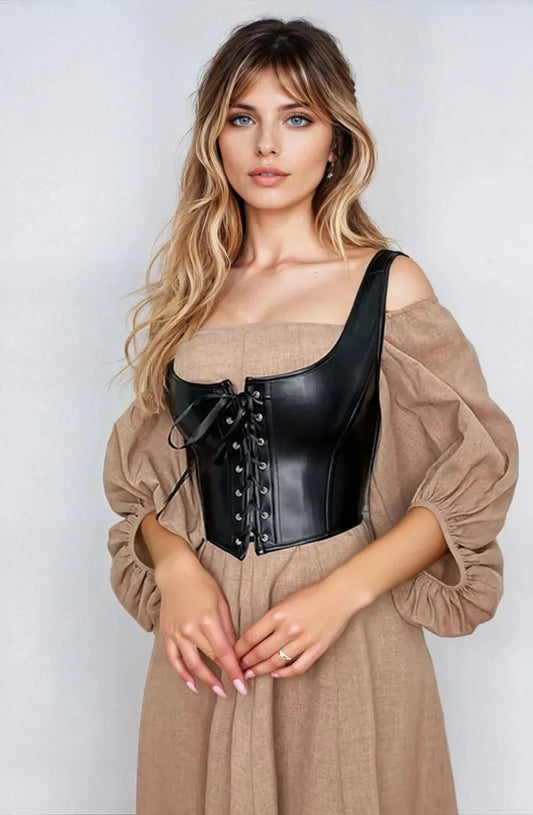 Model wearing YesX black corset with lace-up detail over a cream dress, showcasing modern and edgy style.